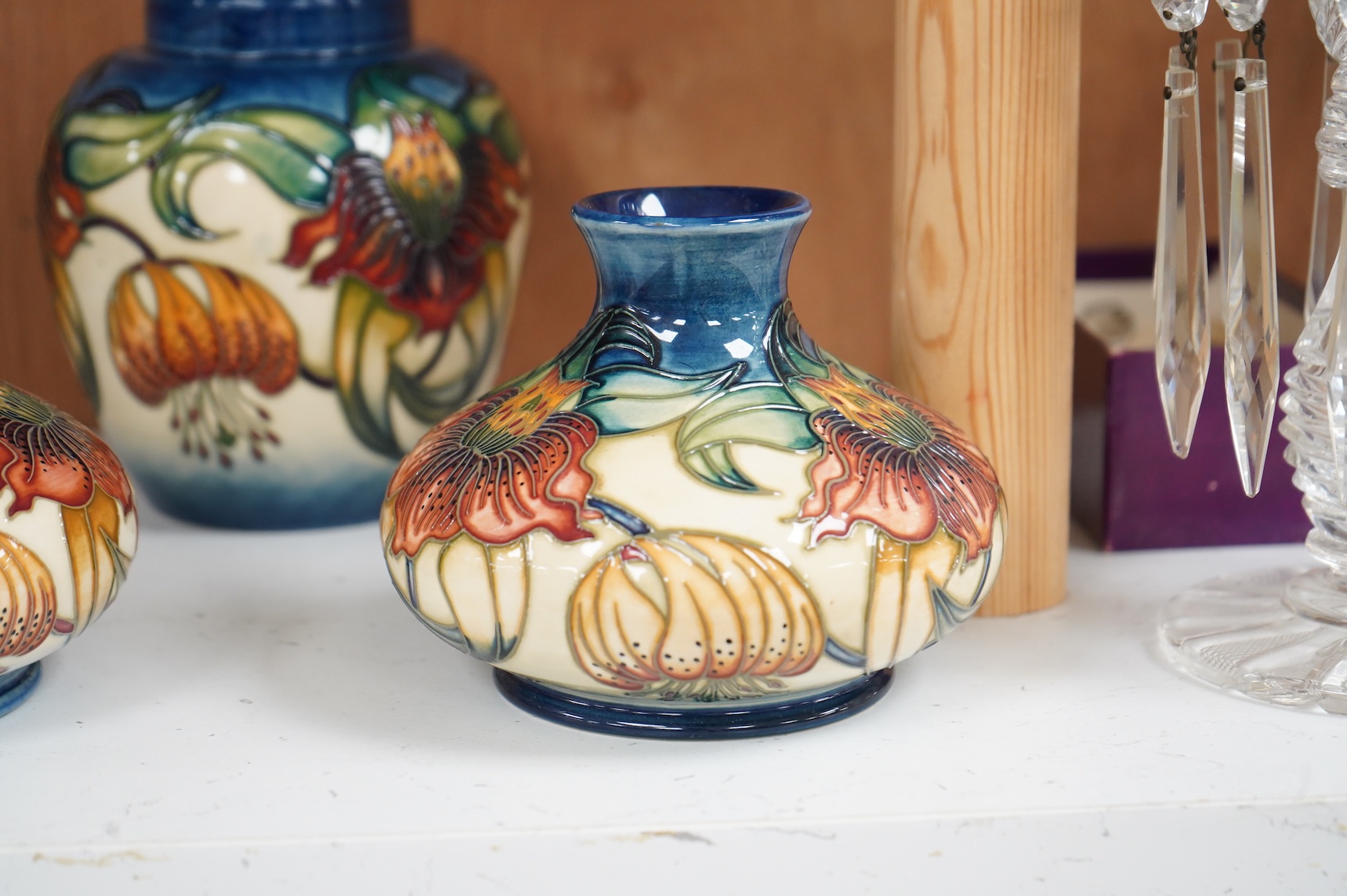 Two modern Moorcroft vases and a jar in the Anna Lily pattern, largest 14cm high
